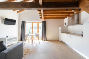a kitchen and living room with a couch and a table at Jardines Villaverde in Villaverde de Pontones