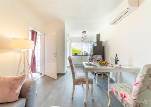 a kitchen and dining room with a table and chairs at Villa Katarin in Komiža