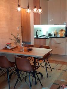 a kitchen with a table and chairs in a kitchen at Amber Gold Apartment in Zlatibor