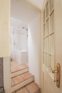 a bathroom with a bath tub and a door at La Casa del Porto in Domaso