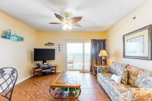 a living room with a couch and a tv at Tropic Isl 501 in Gulf Shores