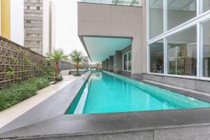 a swimming pool in the middle of a building at Vossa Bossa VN Turiassu in Sao Paulo