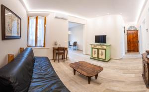 a living room with a couch and a table at EM Apartment in Siena