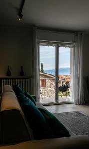 a living room with a large window with a view at Casa blu in Lazise