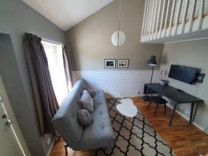 a living room with a couch and a table at Venngarn 304 in Sigtuna