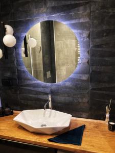 a bathroom with a sink and a mirror at Apartament Centrum Bocian in Białystok