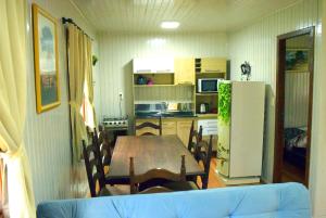 eine Küche und ein Esszimmer mit einem Tisch und einem Kühlschrank in der Unterkunft Pousada Bauernhof in Nova Petrópolis