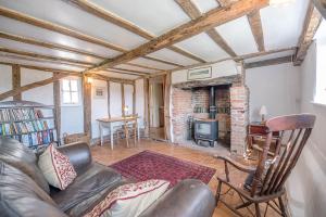 a living room with a couch and a fireplace at Heart's Ease in Dallinghoo nr Woodbridge - Air Manage Suffolk in Woodbridge