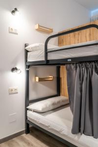 a room with bunk beds in a dorm room at Four Rooms Hostel in Lugo