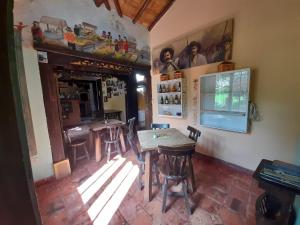 a dining room with tables and chairs in a room at Pueblito Boyacense, Hotel Boutique La Cueva de la Luna in Duitama