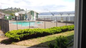a view of a pool through a fence at Alsi Resort Hotel in Waldport