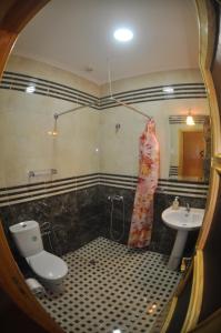 a bathroom with a toilet and a sink at Coopérative Village Jbel Moussa du Tourisme in Rcham +22 photos