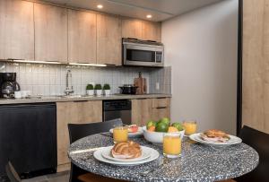 a kitchen with a table with plates of food on it at The Crystal Lodge in Whistler