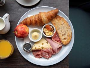 a plate of food with a sandwich and bread and eggs at Queens Hotel & Spa Bournemouth in Bournemouth +43 photos