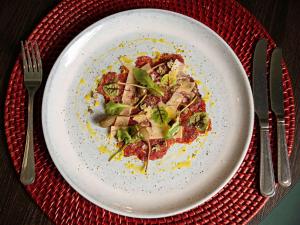 a plate of food on a table with fork and knife at Queens Hotel & Spa Bournemouth in Bournemouth