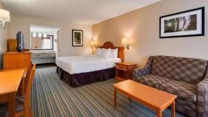 a hotel room with a bed and a couch at Best Western of Murphy in Murphy