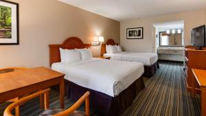 a hotel room with two beds and a desk at Best Western of Murphy in Murphy