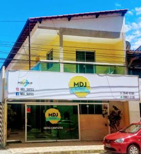 a building with a nid signs on the front of it at MDJ Suítes in Cabo Frio
