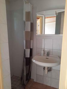a bathroom with a sink and a mirror at Apartment Balatonvilagos - Balaton 30360 in Balatonaliga