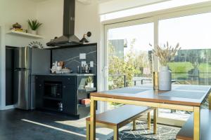 a kitchen with a table and a large window at Ironwood Grove, Tiny House Hotel in Nashville