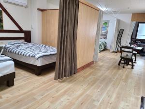 - une chambre avec un lit et du parquet dans l'établissement Aoi sanmyaku, à Awase