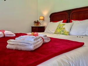 a bedroom with a bed with towels on it at Casa do Pomar - Eido do Pomar in Arcos de Valdevez