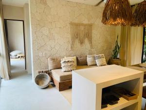 a living room with a couch and a table at Vida Boho Apart 10 with special fee to access Hotel Bardo in Tulum +24 photos