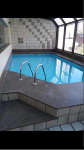 a large swimming pool with two faucets in it at apartamento otima localizacao itaim bibi in Sao Paulo