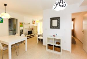 een eetkamer en een woonkamer met een witte tafel en stoelen bij Apartamento Las Alondras 3-6PAX by costablancarent in Denia