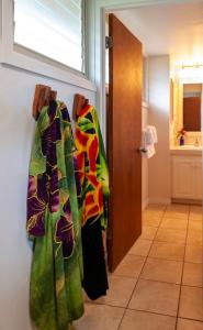 a bathroom with a robe hanging on a wall at Hanalei Colony Resort E1 in Hanalei