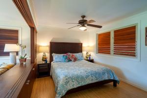 a bedroom with a bed and a ceiling fan at Hanalei Colony Resort E1 in Hanalei