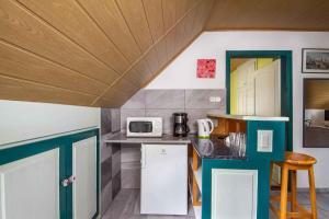 a kitchen with a white refrigerator and a microwave at Apartments in Balatonmariafürdo - Balaton 19491 in Balatonmáriafürdő +9 photos