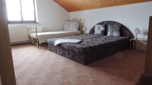 a bedroom with a bed and a bench in it at Holiday home Sedlonov/Adlergebirge 949 in Sedloňov