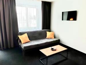 a living room with a couch and a coffee table at Poleczki Residence Apartments in Warsaw