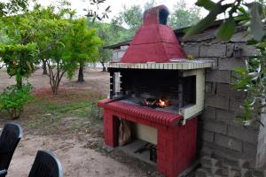 a red brick oven with a fire in it at Studios Alexandros in Sarti