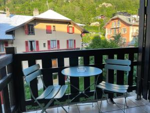 a table and chairs on a balcony with a view at La Comtesse in Saint-Gervais-les-Bains