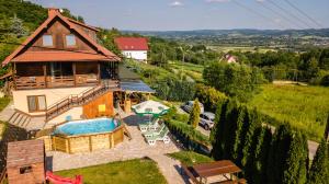 an aerial view of a house with a swimming pool at Willa Sulimówka - wyjątkowy dom na wyłączność Mini SPA in Zakliczyn