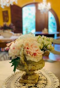 un vase rempli de fleurs sur une table dans l'établissement B&b Casa Penelope, à Stiava