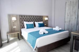 a bedroom with a large bed with two pillows on it at GERANI apartments in Órmos