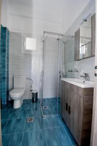 a bathroom with a toilet and a sink and a shower at GERANI apartments in Órmos