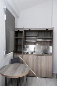 a kitchen with a wooden table and a wooden counter top at GERANI apartments in Órmos