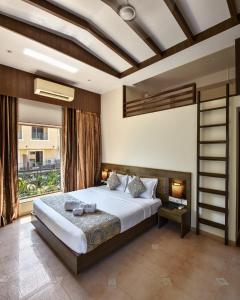 a bedroom with a large bed and a large window at Meritas Crystal Resort in Lonavala
