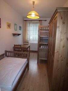 a bedroom with two bunk beds and a table at Apartmány U Lanovky in Rokytnice nad Jizerou