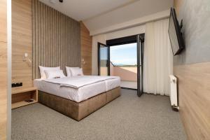 Postel nebo postele na pokoji v ubytování Holiday Park Zagyland + 37 fotografií