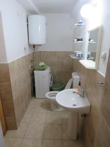 a bathroom with a toilet and a sink at Apartments Jovanović in Perast