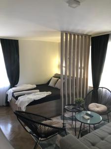 a room with a bed and chairs and a couch at Lux - Apartment BCN in Budva