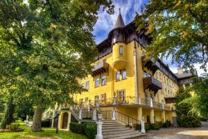 a yellow building with stairs in front of it at Hotel Marienhof in Reichenau