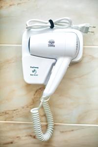 a white electric hair dryer sitting on a counter at Hotel Loft Кароліно-Бугаз in Zatoka +58 photos