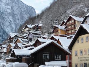 a village covered in snow with mountains in the background at Haus Salzkammergut in Obertraun