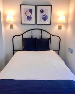 um quarto com uma cama com duas fotografias na parede em Angel Suites em Nicósia